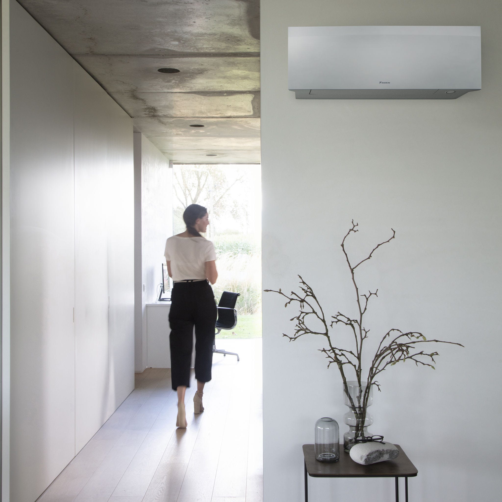 lady walking down to office Aircon on wall